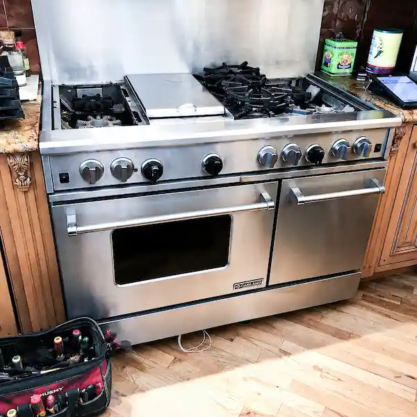 Garland appliance repair technician servicing a commercial Garland range in Los Angeles