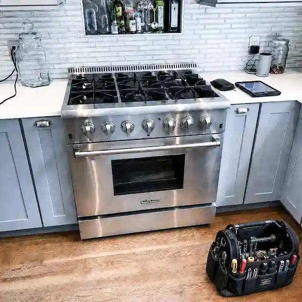 Thor appliance repair technician servicing a pro-style Thor kitchen appliance in Los Angeles